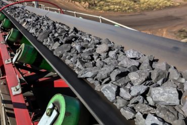 Close up of Manganese rock being moved on a conveyor belt